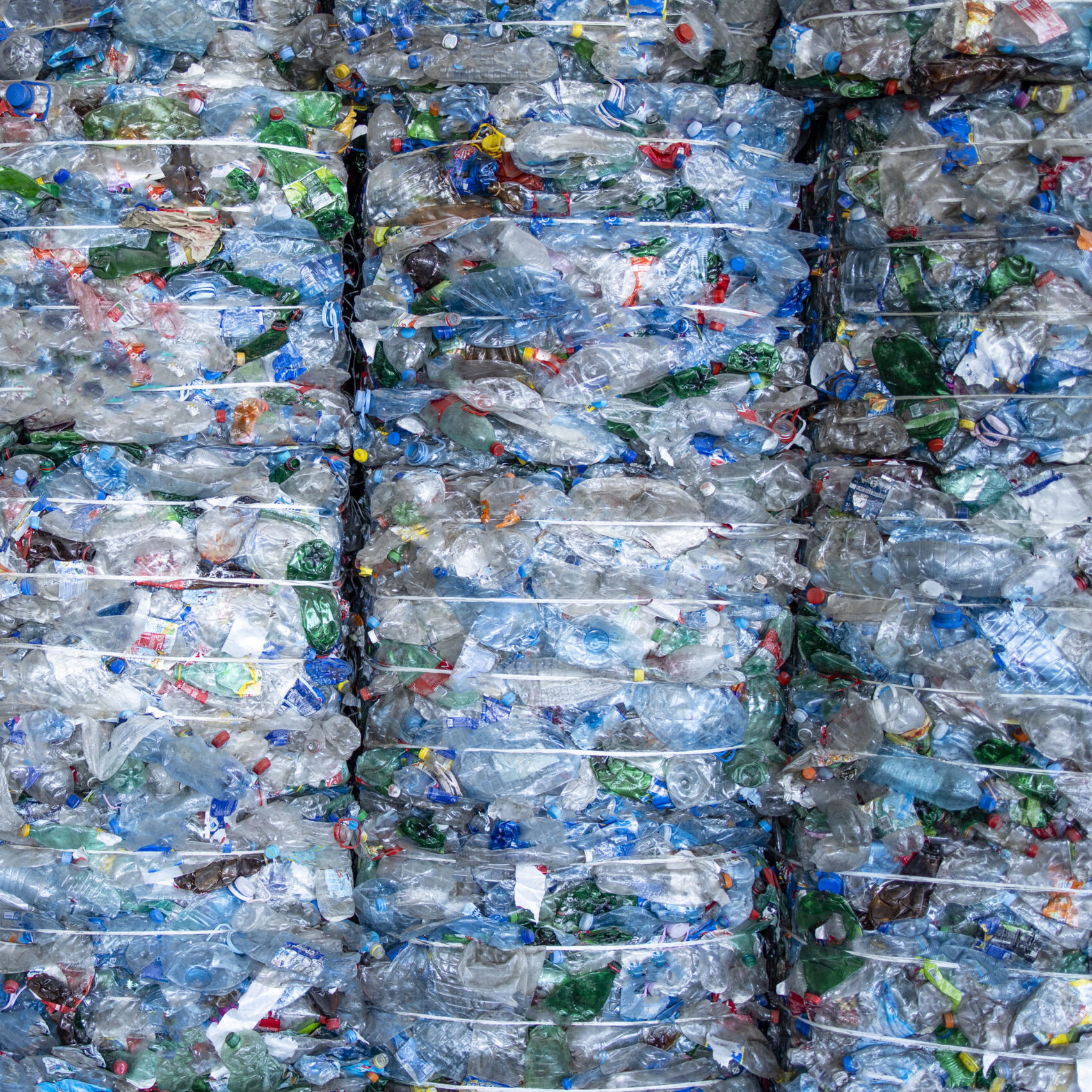 Large pile of plastic PET bottles compressed and ready for recycling.